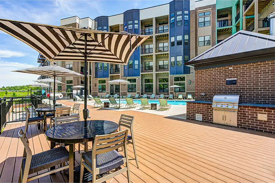 Outdoor spaces like this one at East Bank Apartments in Noblesville make life more enjoyable. Outdoor seating area and grilling station at East Bank Apartments in Noblesville