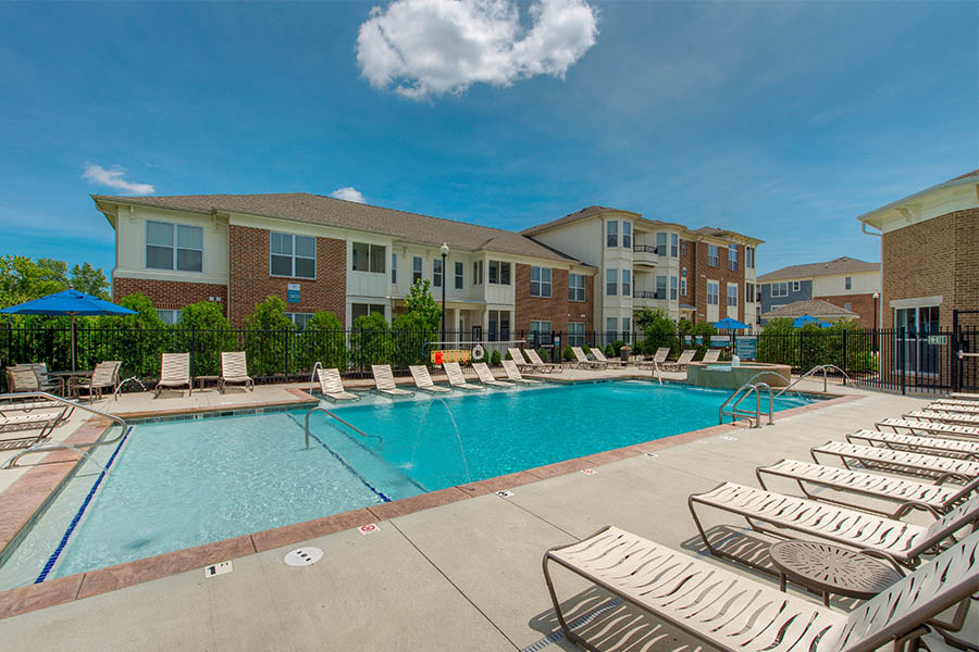 Swimming pool and outdoor seating at apartment.