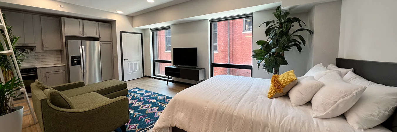 A wide view of a decorated studio apartment